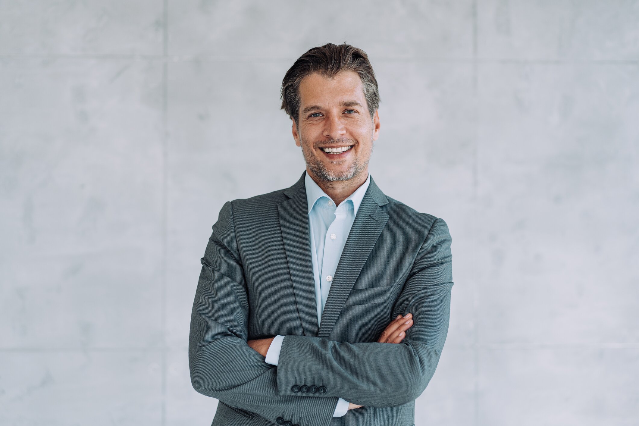 Beverly Hills dental crowns model with brown hair in a suit